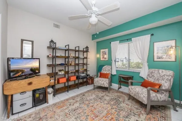 a bedroom with furniture and a book shelf