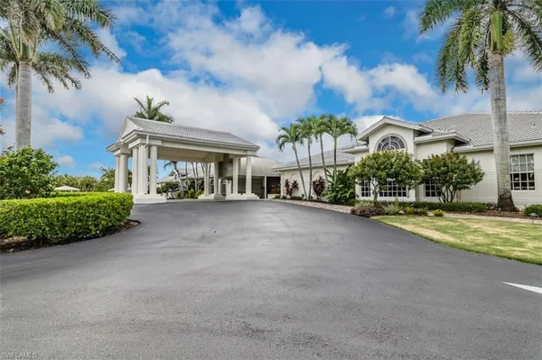 a view of a house with a large trees and outdoor space