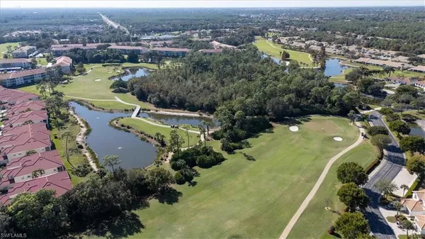 an aerial view of residential houses with outdoor space and river