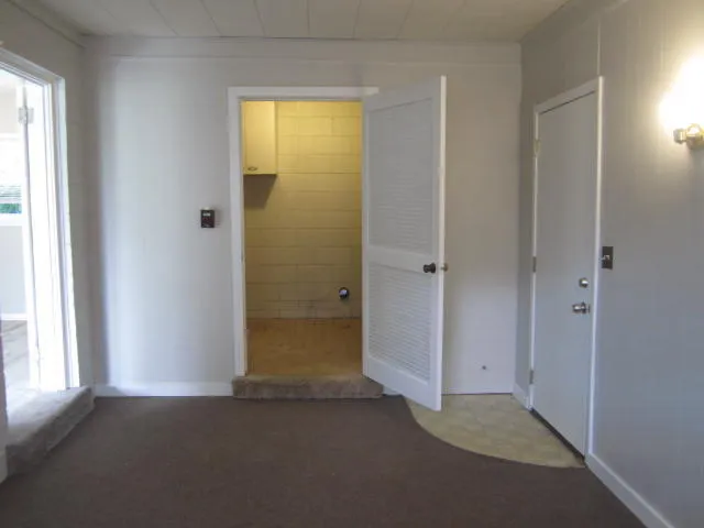 an empty room that has a window in it