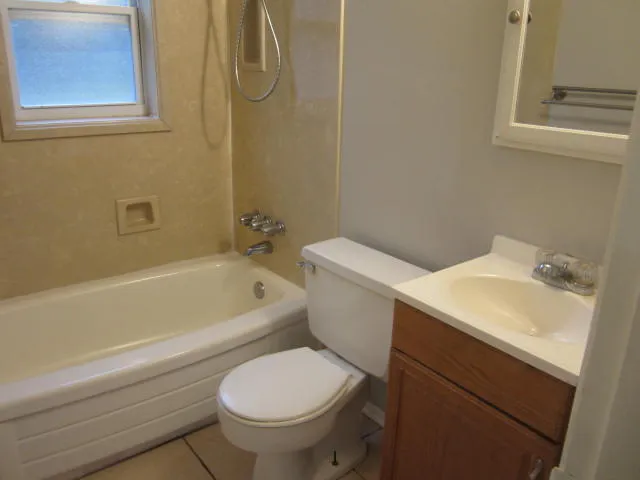 a white toilet sitting next to a bath tub