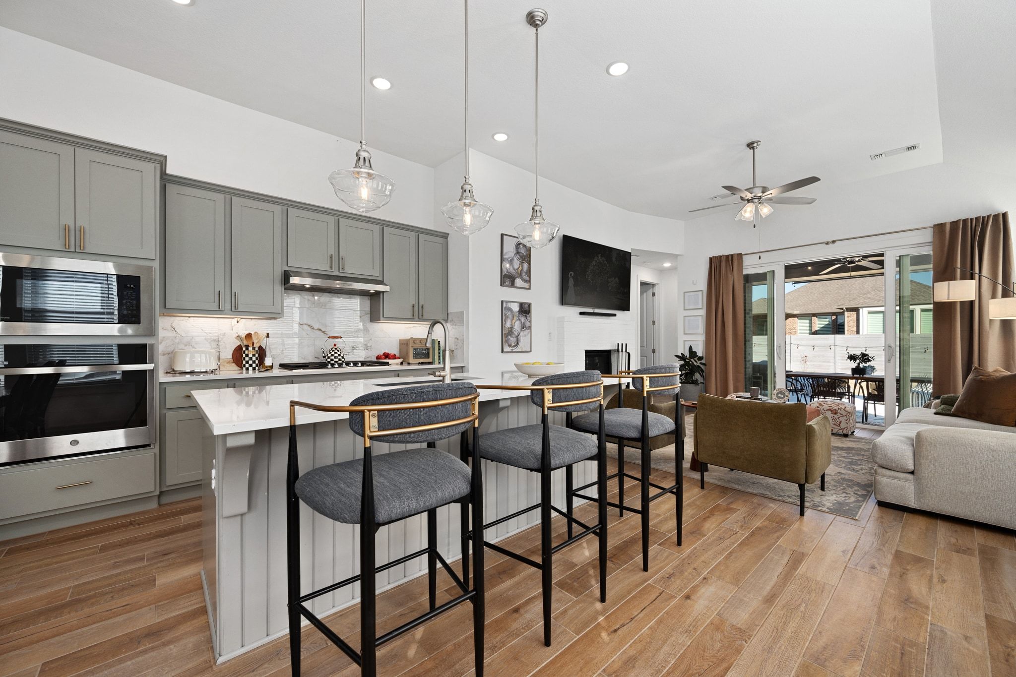 1201 Highcrest Georgetown, TX 78628 - Photo 14 of 40 a kitchen with stainless steel appliances granite countertop a stove a refrigerator a kitchen island a dining table and chairs with wooden floor