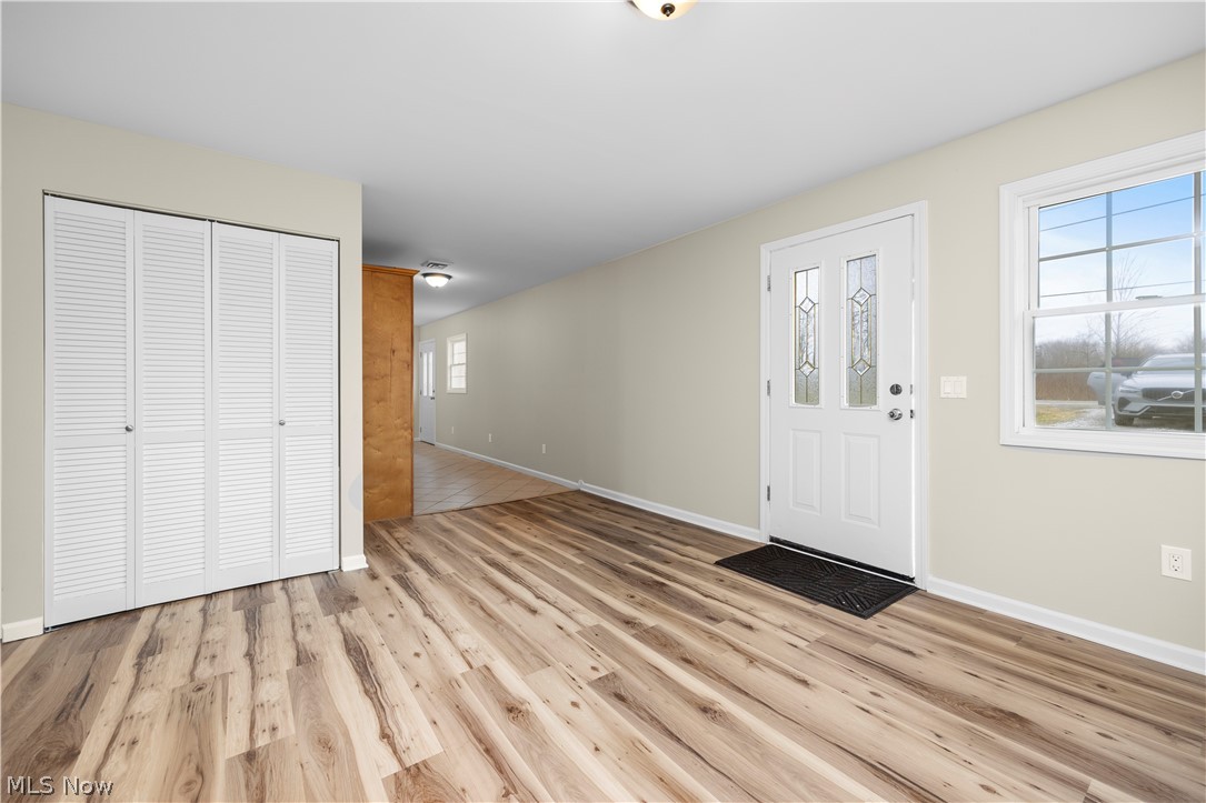 12452 Island Road Grafton, OH 44044 - Photo 4 of 39 Entryway with baseboards and light wood-style flooring