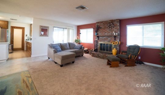 4617 West Ridgecrest Boulevard Ridgecrest, CA 93555 - Photo 3 of 33 a living room with furniture and a fireplace