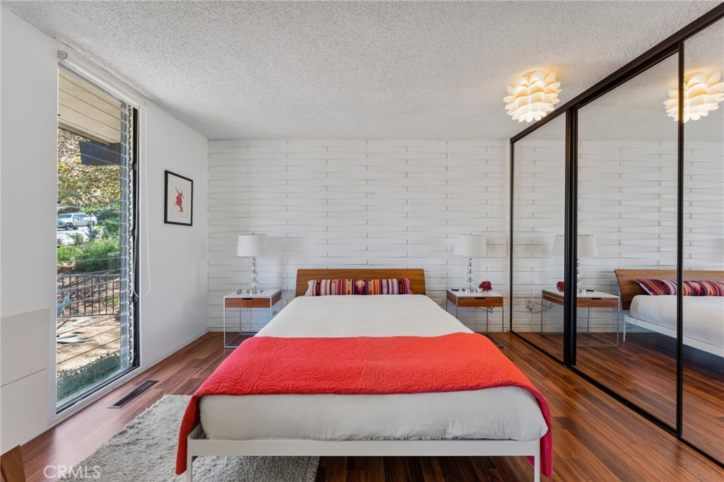 4259 Quail Road Riverside, CA 92507 - Photo 33 of 72 a bedroom with a bed and wooden floor