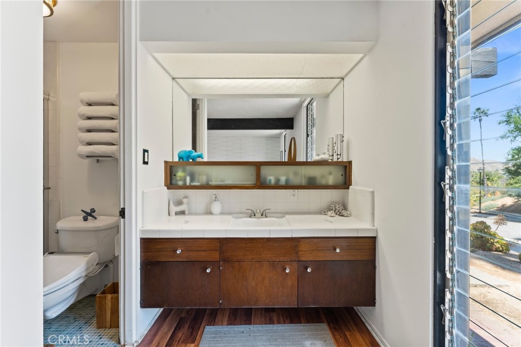 4259 Quail Road Riverside, CA 92507 - Photo 35 of 72 a bathroom with a sink and a mirror