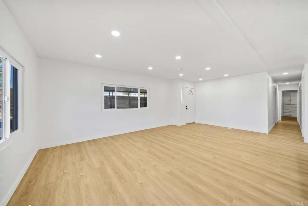 8301 Mission Gorge Road, Unit 253 Santee, CA 92071 - Photo 20 of 40 a view of an empty room with wooden floor and a window