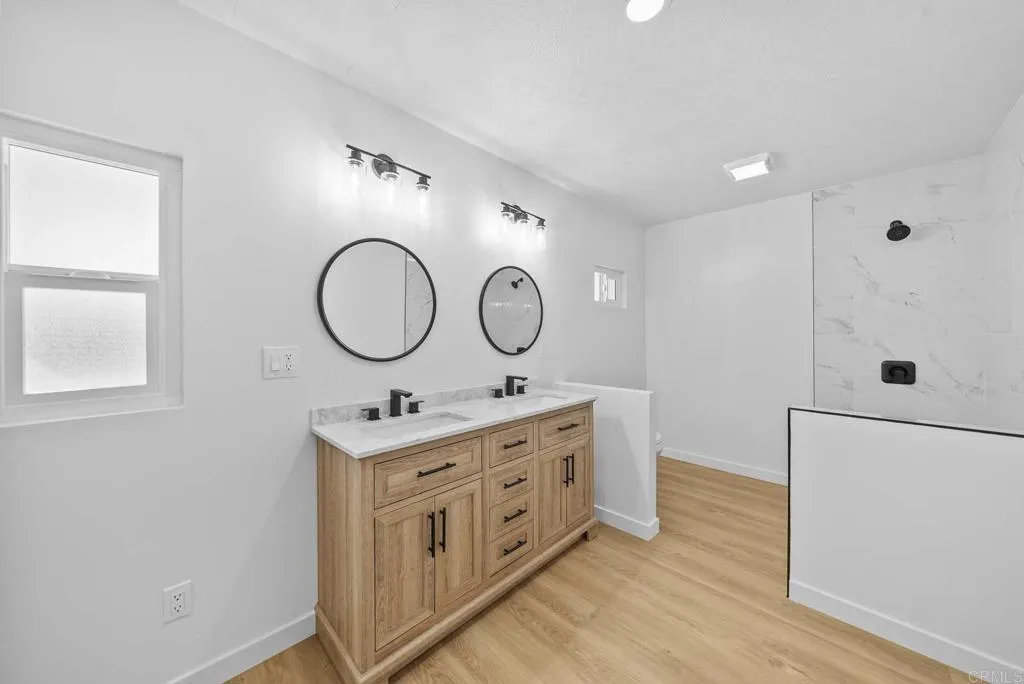 8301 Mission Gorge Road, Unit 253 Santee, CA 92071 - Photo 27 of 40 a bathroom with a double vanity sink and a mirror