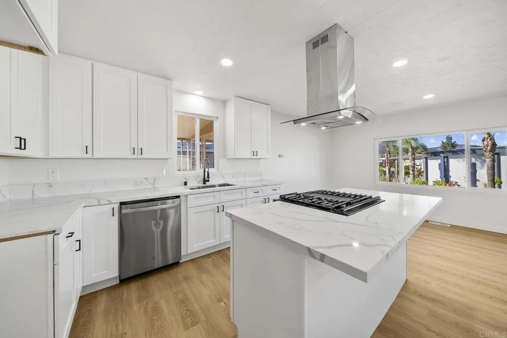 8301 Mission Gorge Road, Unit 253 Santee, CA 92071 - Photo 6 of 40 a kitchen with granite countertop a sink a stove and wooden floors