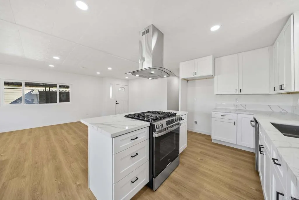 8301 Mission Gorge Road, Unit 253 Santee, CA 92071 - Photo 7 of 40 a kitchen with stainless steel appliances granite countertop a stove and a sink