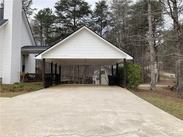a front view of a house with yard and trees