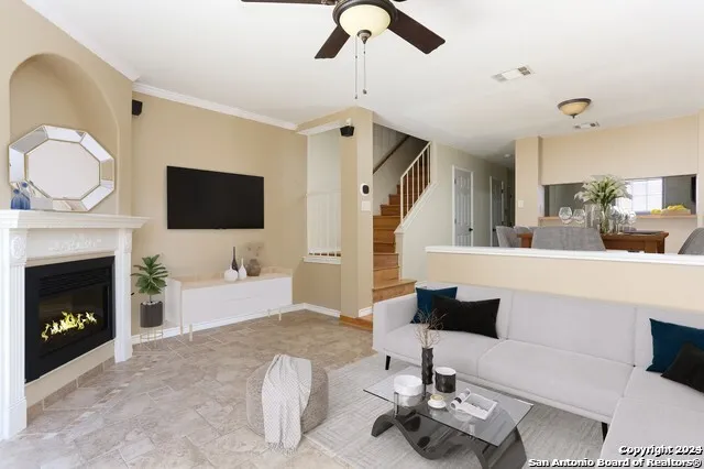 a living room with furniture a fireplace and a flat screen tv