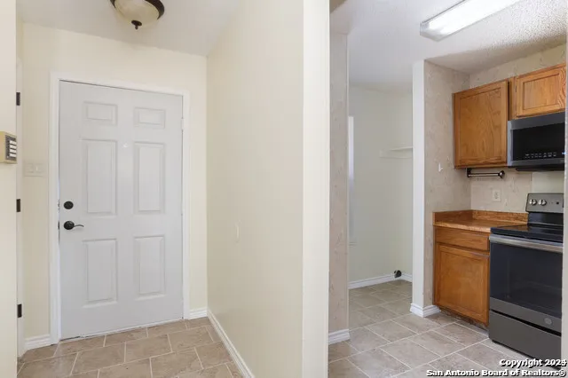 a kitchen with a refrigerator and a stove