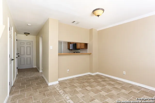 a view of a kitchen with a sink and a refrigerator
