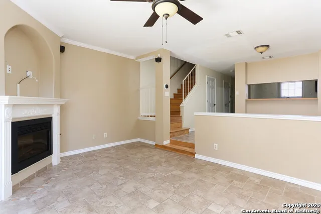 a view of an empty room with cabinet and a fireplace