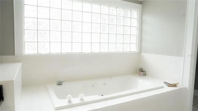 a white bath tub sitting next to a window