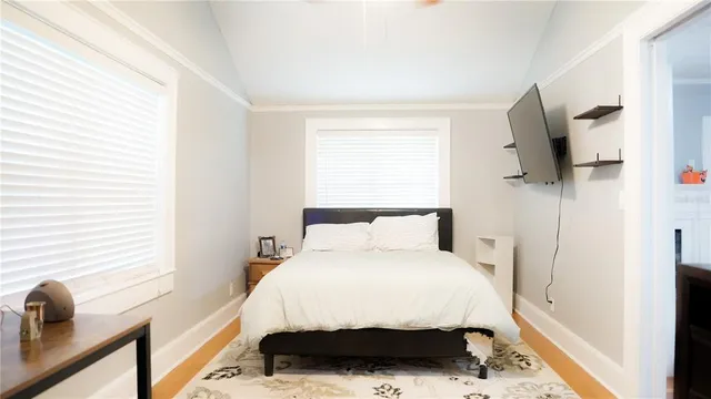 a bedroom with a bed and flat screen tv