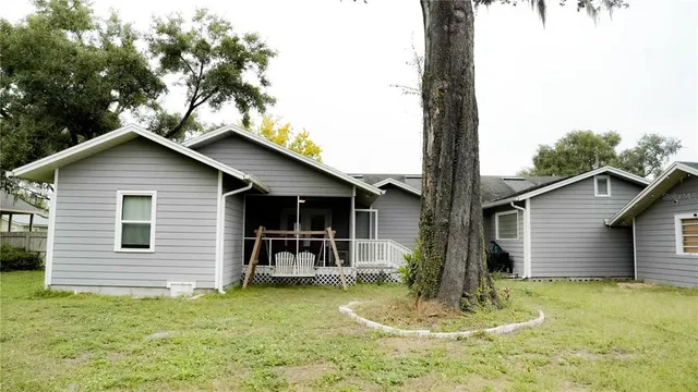 a backyard of a house with yard fountain and barbeque oven