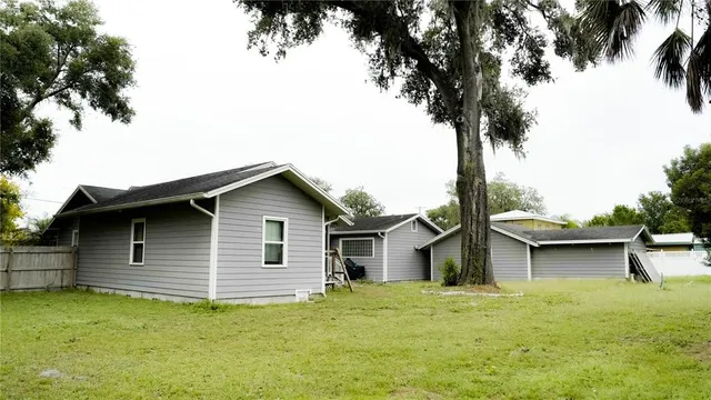 a backyard of a house with table and chairs