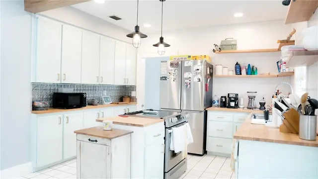 a kitchen with a sink a stove and a refrigerator