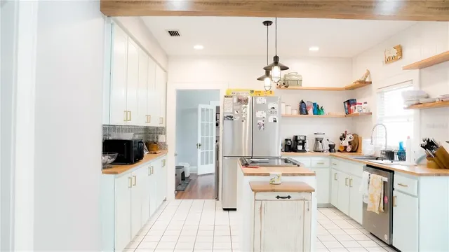 a kitchen with stainless steel appliances and white cabinets