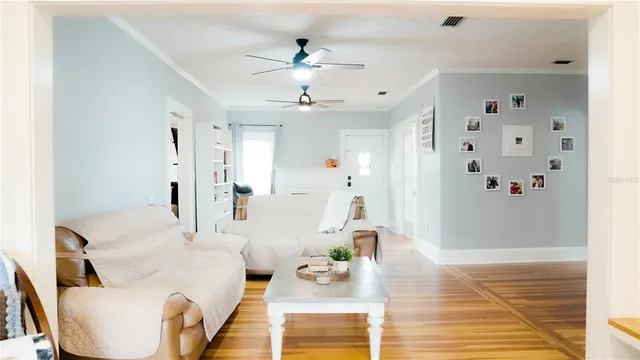 a living room with furniture and a chandelier