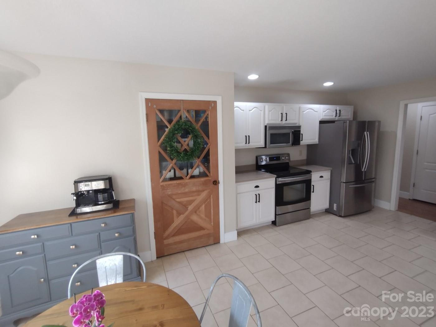 80 South Sunset Ridge Drive Etowah, NC 28729 - Photo 12 of 48 a kitchen with stainless steel appliances a refrigerator sink and stove