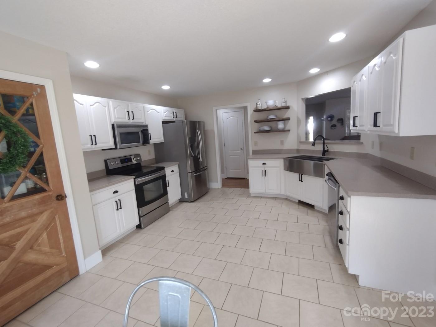 80 South Sunset Ridge Drive Etowah, NC 28729 - Photo 13 of 48 a large kitchen with a large counter top appliances and cabinets