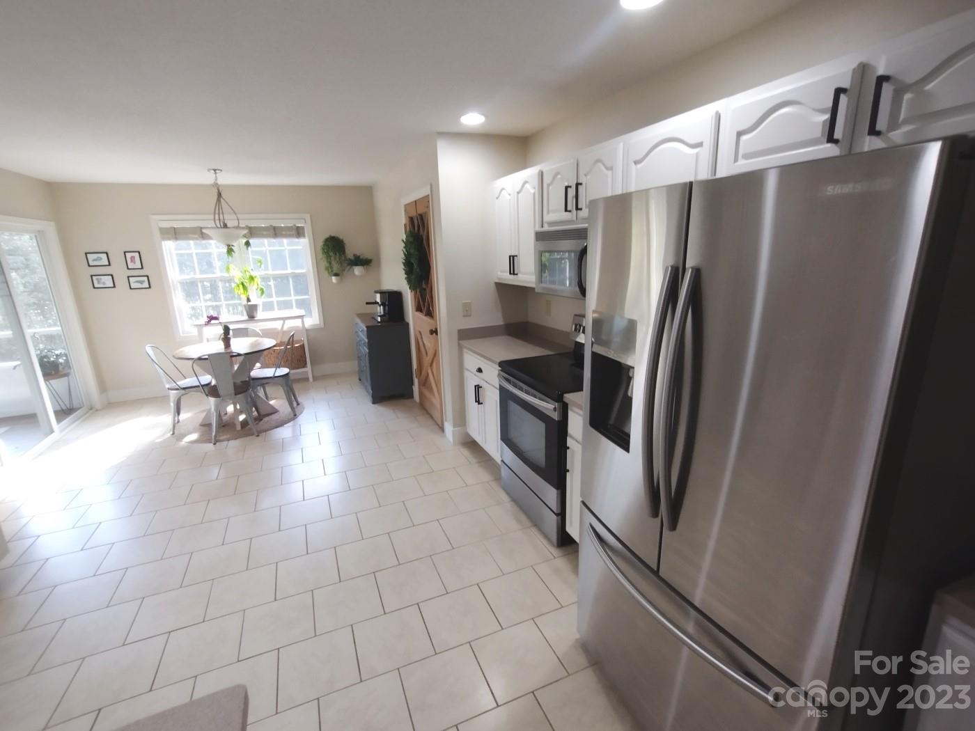 80 South Sunset Ridge Drive Etowah, NC 28729 - Photo 16 of 48 a kitchen with stainless steel appliances a refrigerator and a counter top space