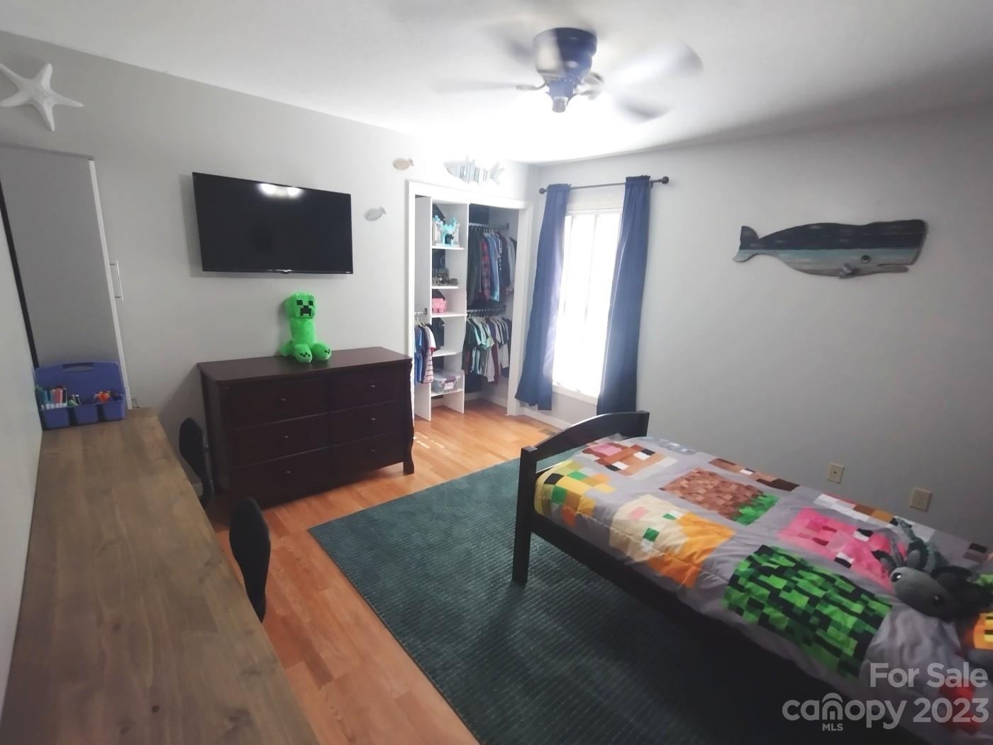 80 South Sunset Ridge Drive Etowah, NC 28729 - Photo 22 of 48 a bedroom with a bed and a flat screen tv