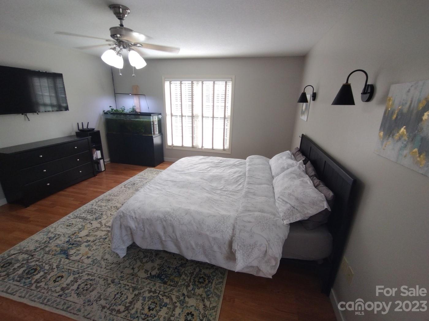 80 South Sunset Ridge Drive Etowah, NC 28729 - Photo 25 of 48 a bed sitting in a bedroom and flat screen tv