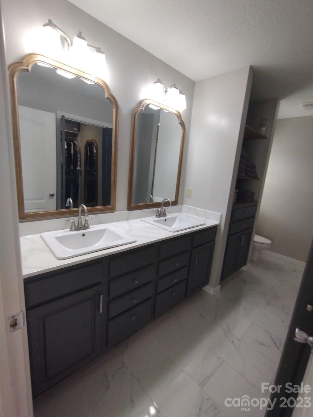 80 South Sunset Ridge Drive Etowah, NC 28729 - Photo 27 of 48 a bathroom with a double vanity sink and a mirror