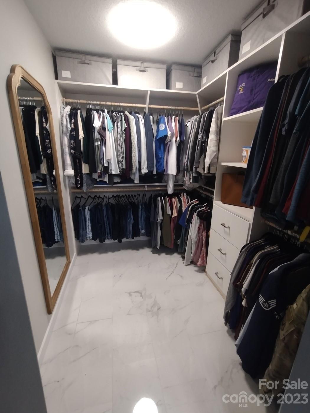 80 South Sunset Ridge Drive Etowah, NC 28729 - Photo 28 of 48 a view of walk in closet with clothes and shoes