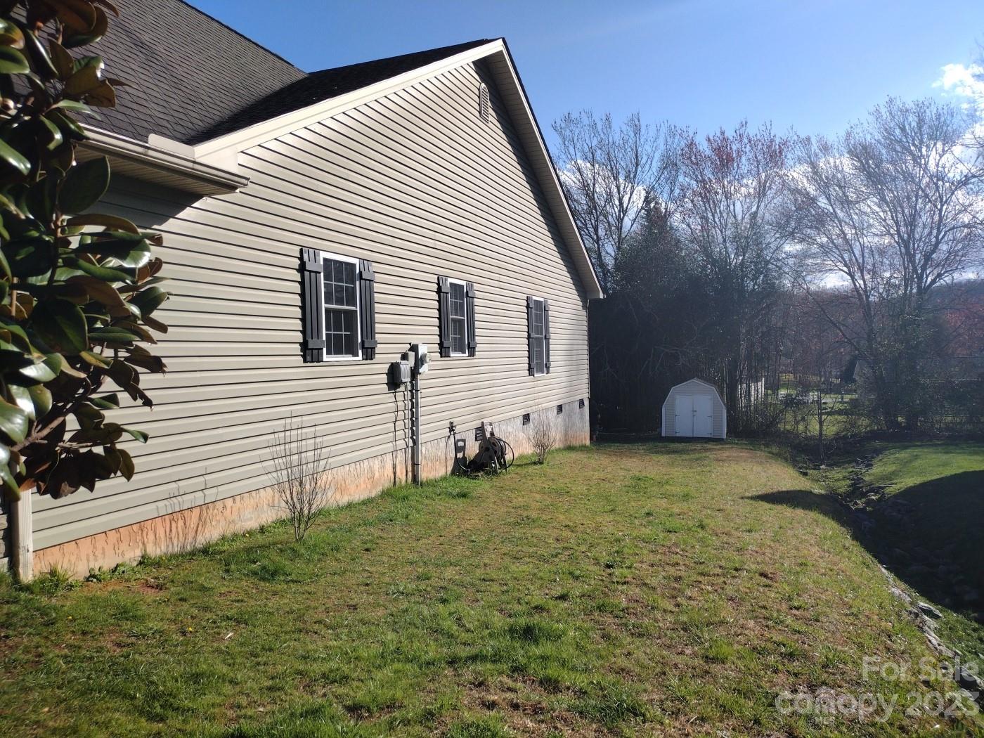 80 South Sunset Ridge Drive Etowah, NC 28729 - Photo 37 of 48 a view of a house with a yard