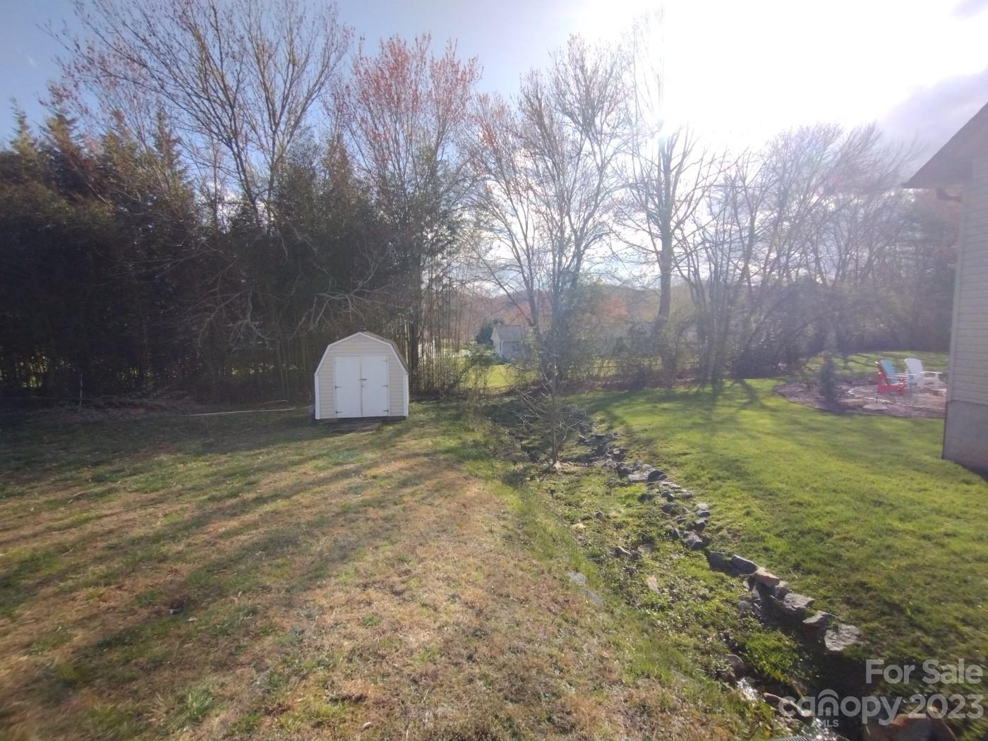 80 South Sunset Ridge Drive Etowah, NC 28729 - Photo 39 of 48 a backyard of a house with lots of green space
