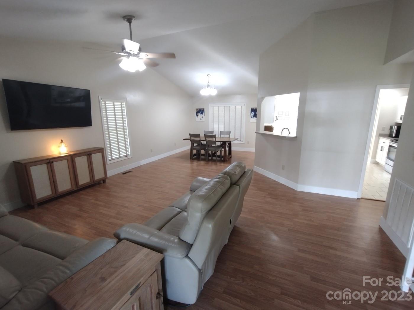 80 South Sunset Ridge Drive Etowah, NC 28729 - Photo 4 of 48 a view of a dining room with furniture a chandelier and wooden floor