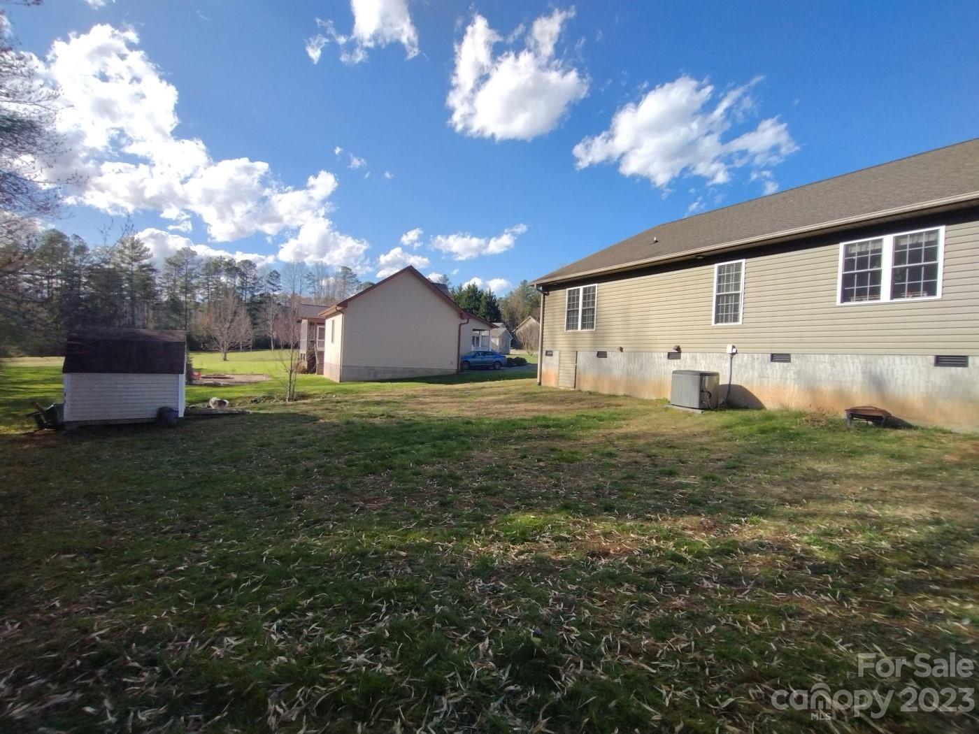 80 South Sunset Ridge Drive Etowah, NC 28729 - Photo 42 of 48 a view of a backyard with potted plants and large tree
