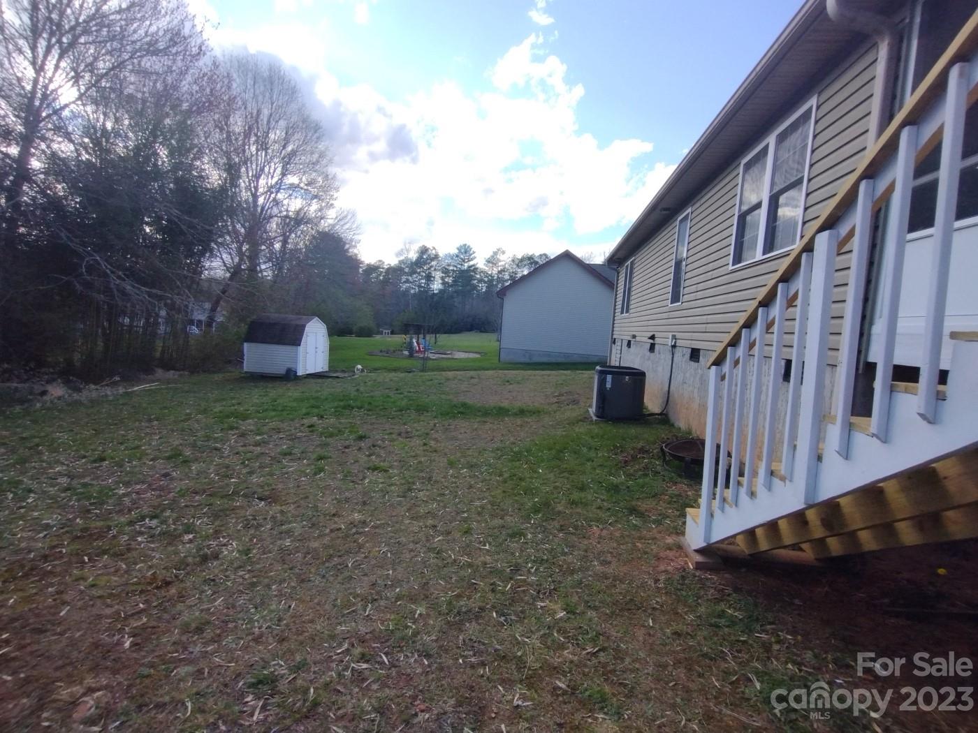 80 South Sunset Ridge Drive Etowah, NC 28729 - Photo 45 of 48 a view of a house with backyard and trees