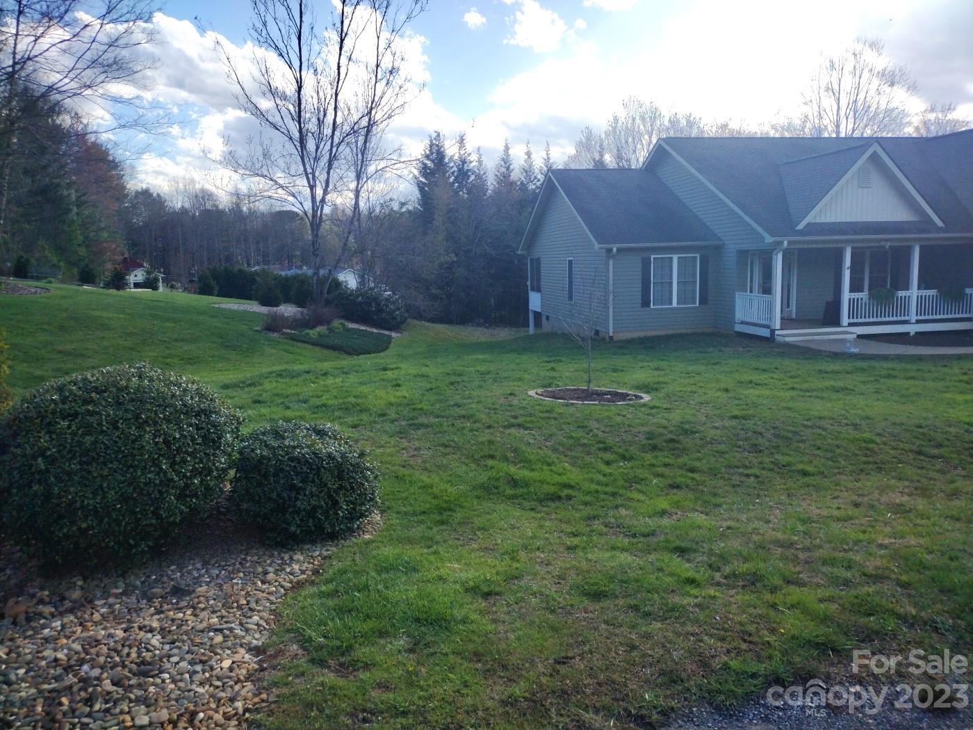 80 South Sunset Ridge Drive Etowah, NC 28729 - Photo 47 of 48 a view of a house with backyard and garden