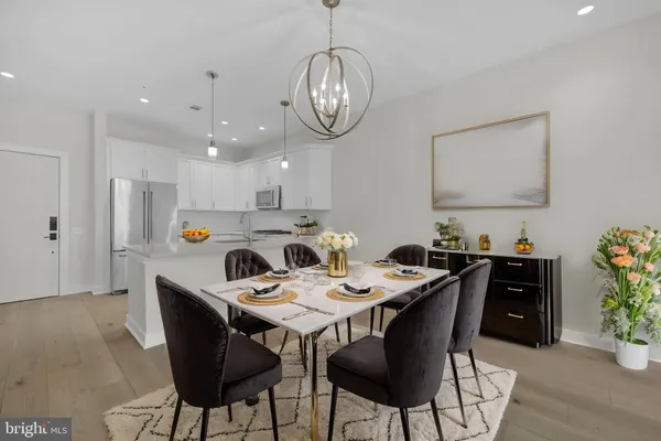 a view of a dining room with furniture wooden floor and a chandelier