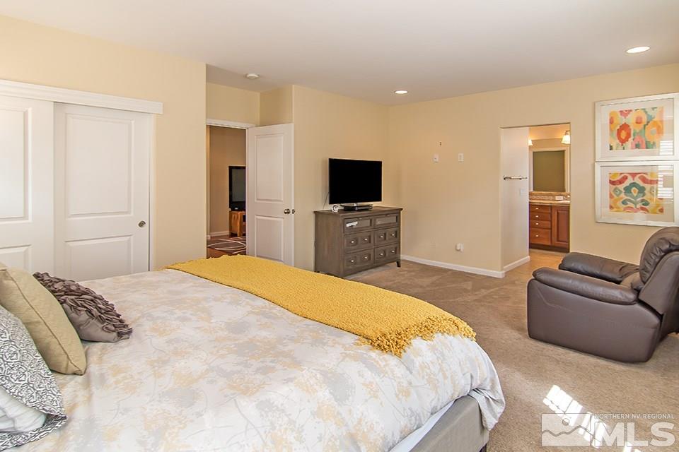 7676 Pebblestone Way Reno, NV 89523 - Photo 16 of 20 a bedroom with a bed and a couch