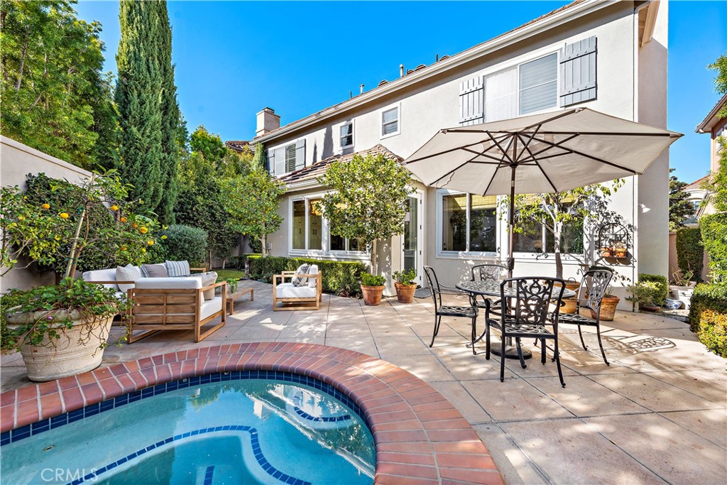 16 Clermont Newport Coast, CA 92657 - Photo 16 of 29 a patio with a table and chairs and potted plants
