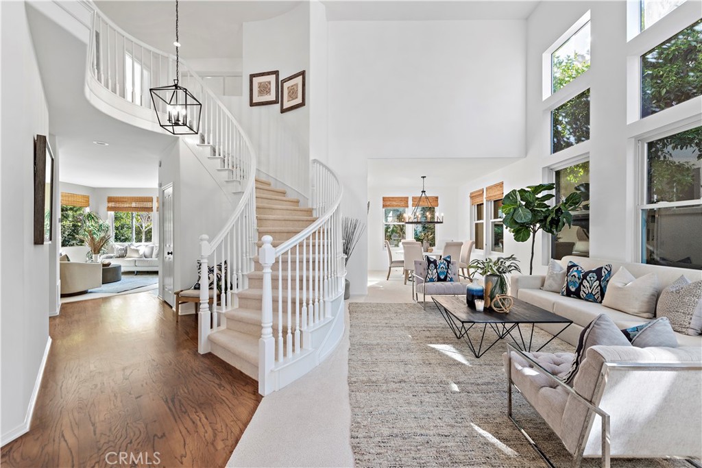 16 Clermont Newport Coast, CA 92657 - Photo 2 of 29 a living room with couches and dining table with wooden floor