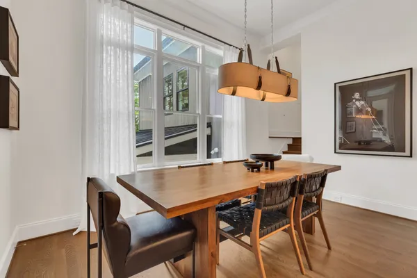 a living room with furniture a window and a flat screen tv