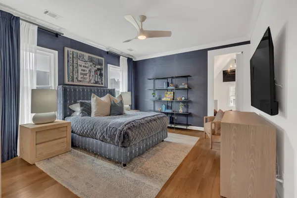a bed sitting in a bedroom next to a window