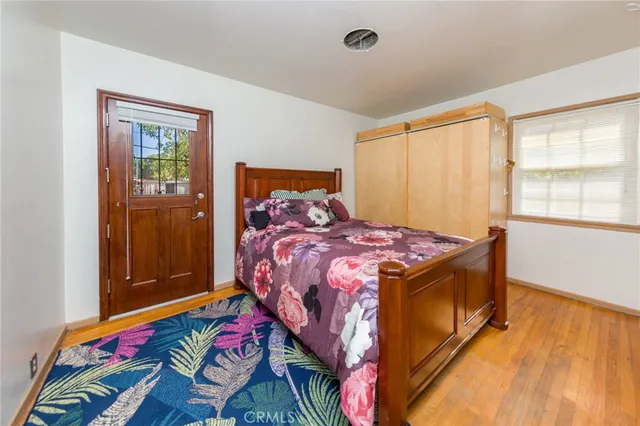 a bed sitting in a bedroom next to a window