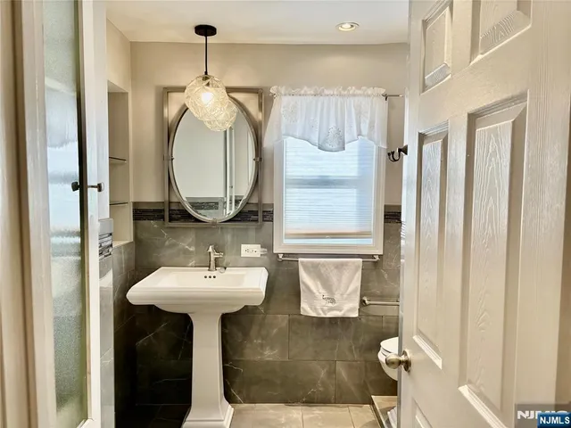 a view of a patio with table and chairs with wooden floor and fence