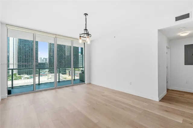 a kitchen with stainless steel appliances granite countertop a refrigerator a stove and a sink with large mirror