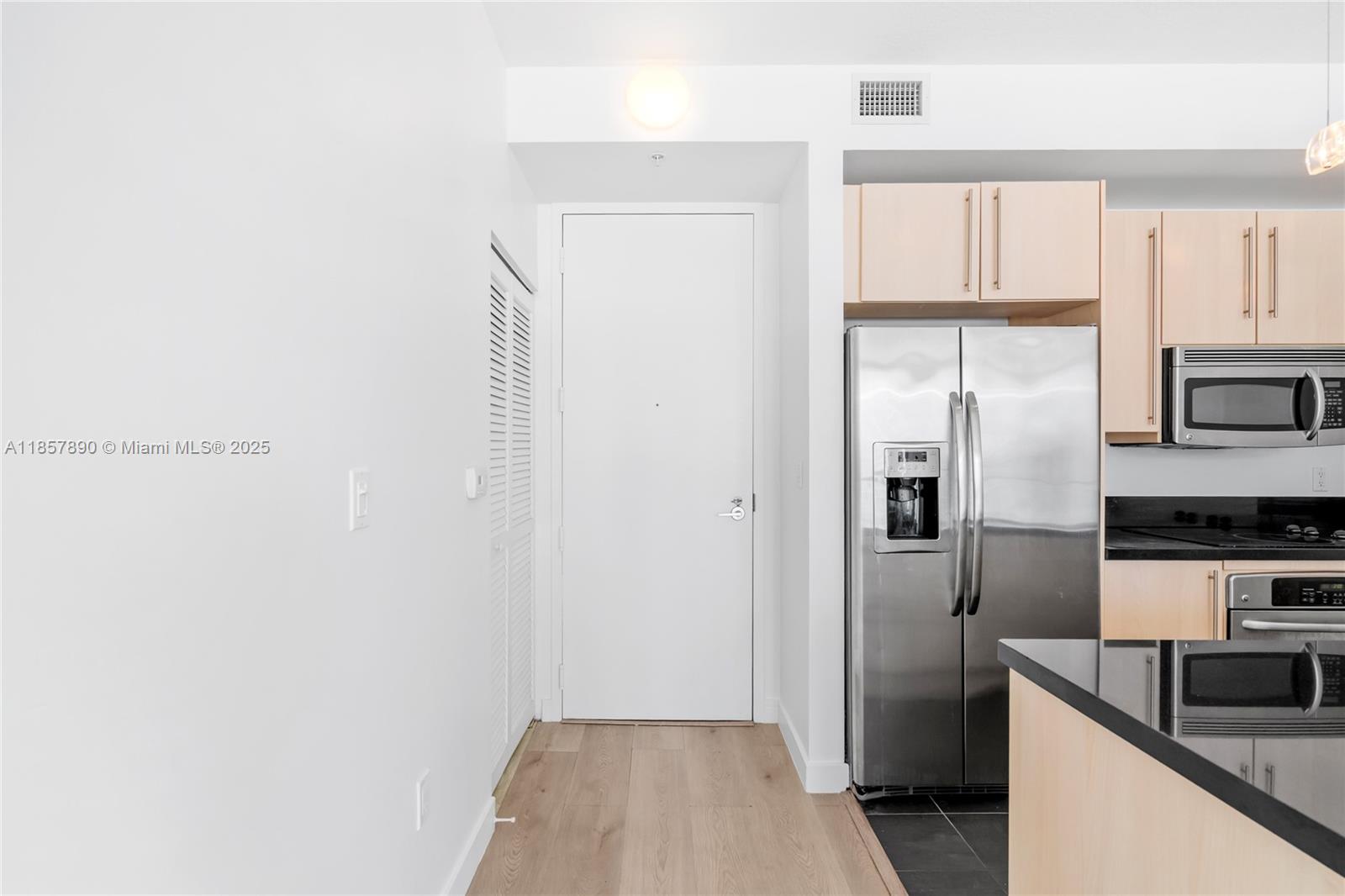 1111 Southwest 1st Avenue, Unit 2222N Miami, FL 33130 - Photo 13 of 53 a kitchen with stainless steel appliances granite countertop a refrigerator and a sink