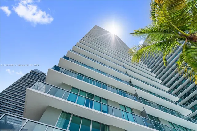 a view of a big building with a big yard and plants